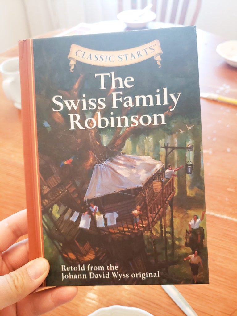 hand holding Swiss family Robinson book 