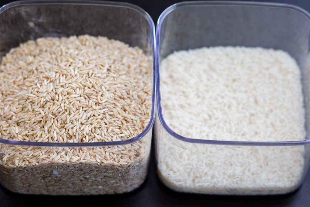 brown and white rice side by side in containers how to store rice long term