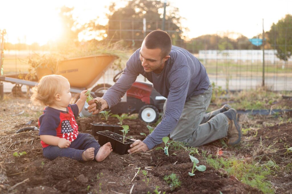 man working in garden with kids