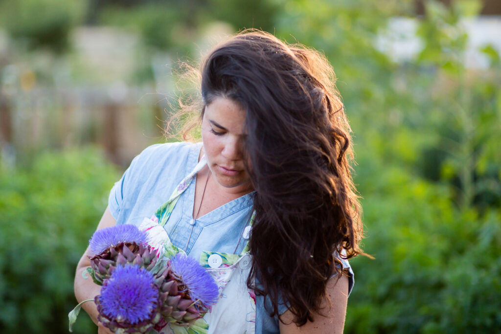 woman holding artichoke bloom