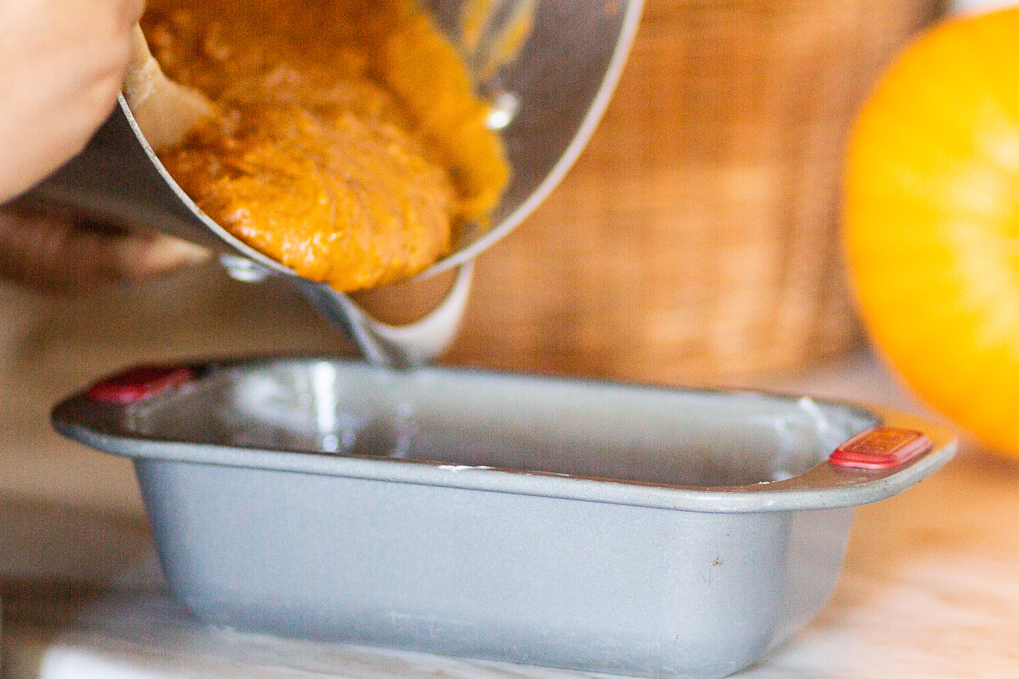 pumpkin bread batter getting poured into pan