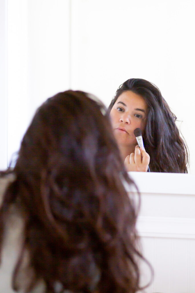 woman getting ready in mirror