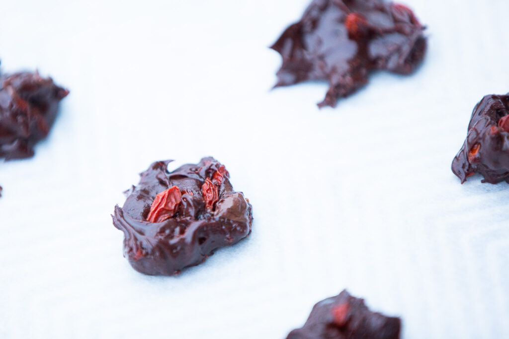 chocolate covered goji berries on baking sheet 