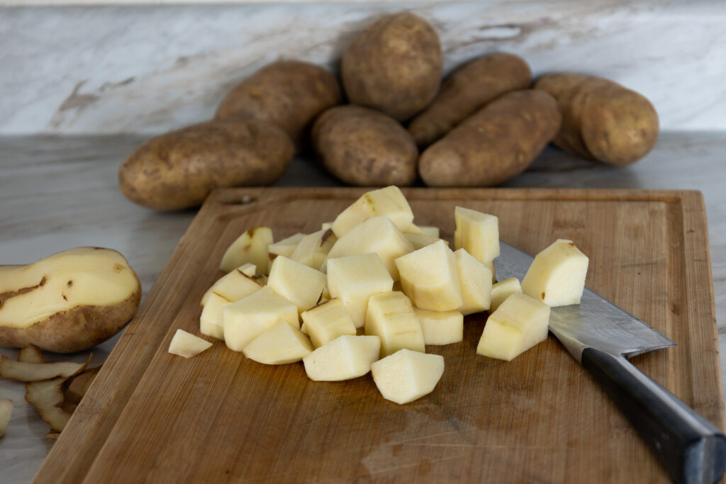 diced potatoes sitting on cutting board