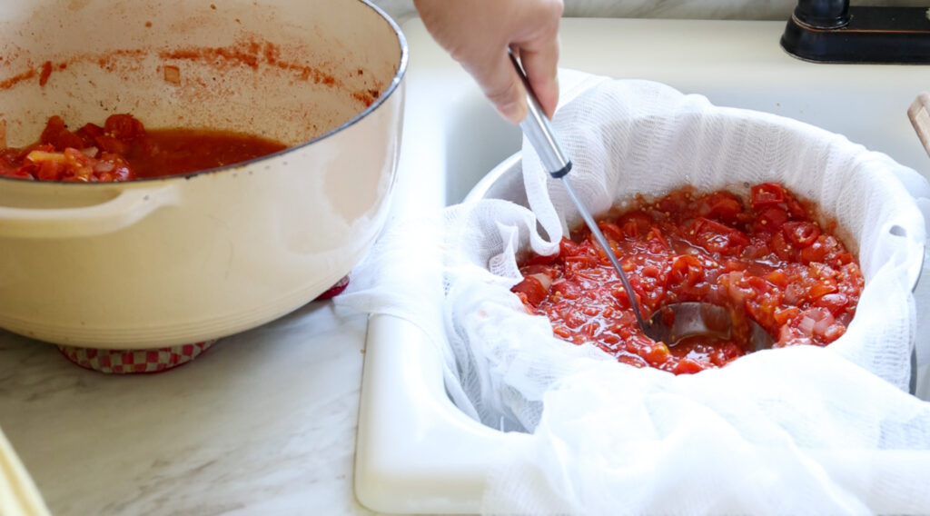 squeezing tomatoes through a sieve 