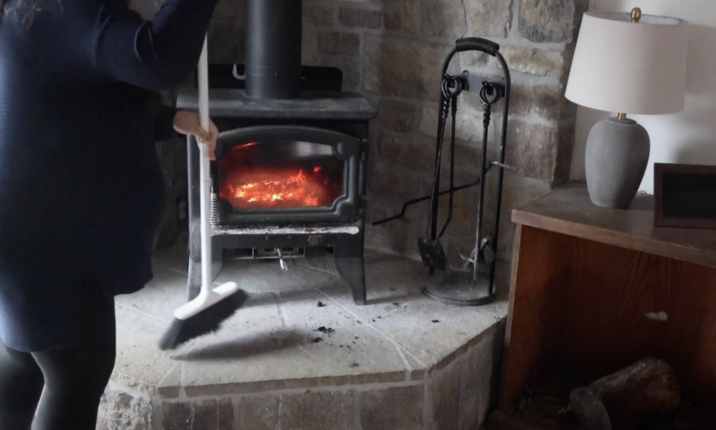 sweeping hearth of wood stove 